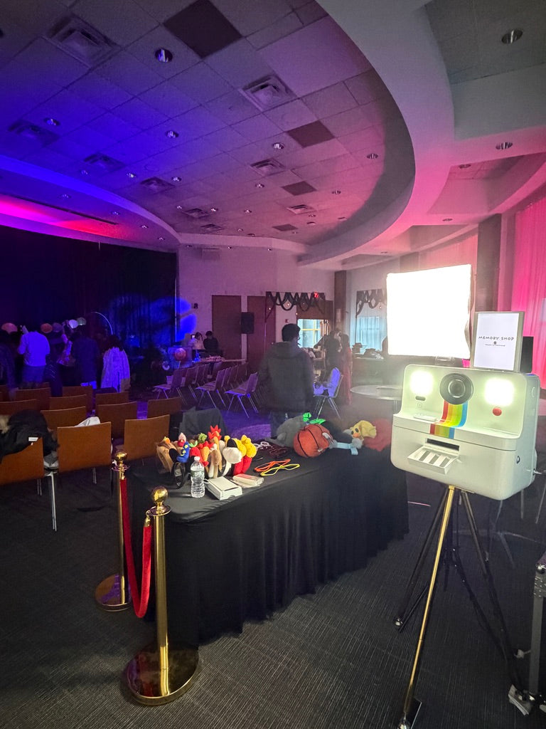 Memory Shop photo booth setup with props and backdrop